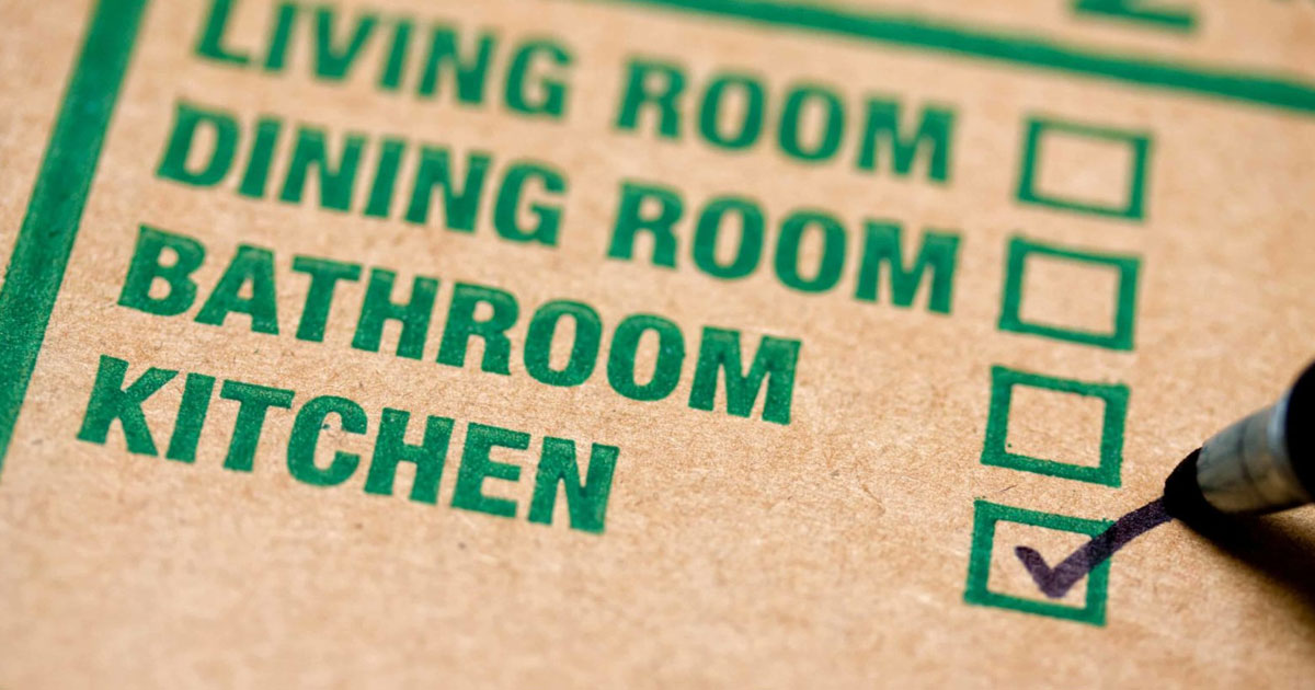carboard box with checkboxes for living room, dinning room, bathroom, and kitchen